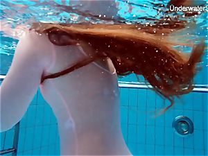 ginger-haired Simonna showing her body underwater